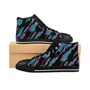May include: A pair of black high-top canvas shoes with a colorful geometric pattern. The shoes have a white sole and laces.