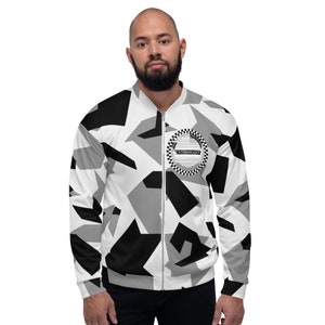 May include: A camouflage bomber jacket in white, black, and grey, with a zip. It has a circular emblem with the word "ENTHUSIAST" and a chequered pattern. The jacket is worn by a person.