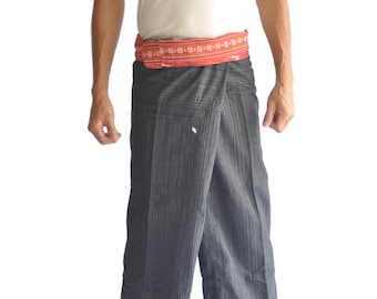 May include: A person wearing a white tank top, gray wrap pants, and a red patterned belt. The pants have a vertical stripe pattern. The belt has a floral design. The background is white.