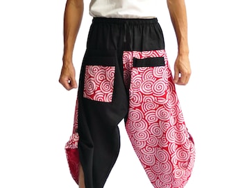 May include: Black and red patterned harem pants with a white spiral design. The pants have a black waistband and pockets. The model is wearing a white tank top. The pants are made of a lightweight fabric.