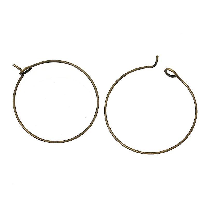 May include: A pair of gold-toned hoop earrings. The earrings are simple and elegant, with a smooth finish.