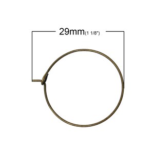 May include: A gold-toned metal hoop earring measuring 29mm (1 1/8 inches) in diameter.