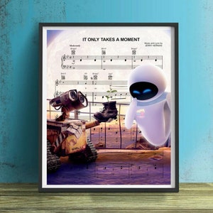 May include: A framed print of a musical score for the song "It Only Takes a Moment" from the movie WALL-E. The score features the characters WALL-E and EVE, a robot couple, standing on a platform with a sunset in the background.