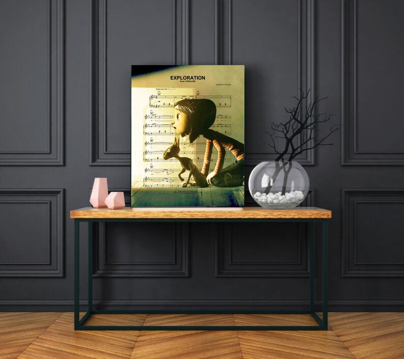 May include: A vintage-style print of a girl and a small creature looking out a window. The print is on a sheet of music with the title "EXPLORATION" at the top. The print is framed and hanging on a wall above a wooden console table.