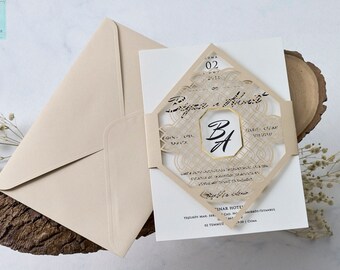 Wedding Invitation. Luxury Beige Envelope with Elegant Laser Cut Stylish Beige Cover. Monogram Detail on Card. Gold Foil Detail on Cover.