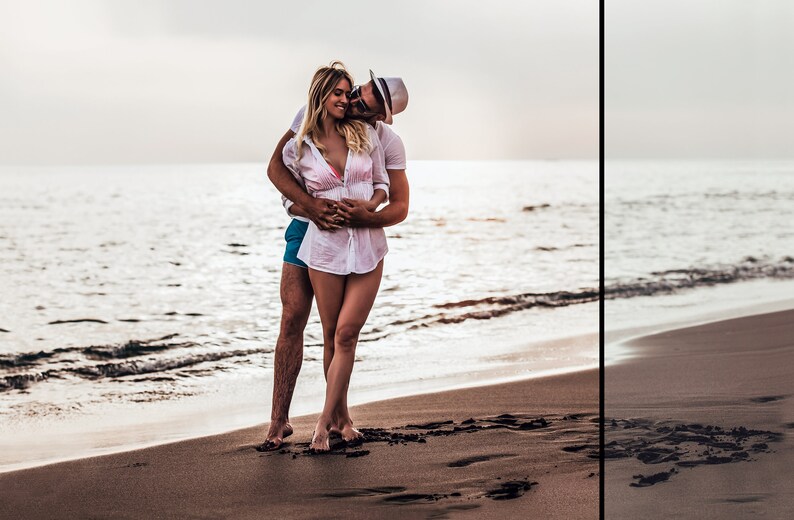 May include: A person with long blonde hair wearing a white button-down shirt over a pink bikini top and blue shorts, embraced by another person wearing a white t-shirt, blue shorts, and a white fedora hat while standing on a sandy beach.
