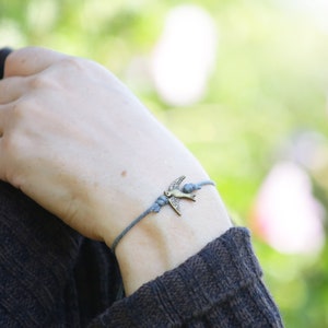 Grey String Bracelet. Bronze Bird