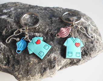 Personalized nursing gown key ring with heart design, mask, stethoscope, and lucky charm.