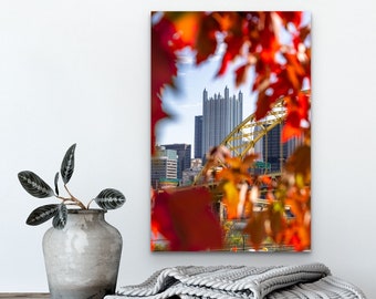 Photo of Pittsburgh with PPG Place and Fort Pitt Bridge Framed by Vibrant Red Leaves