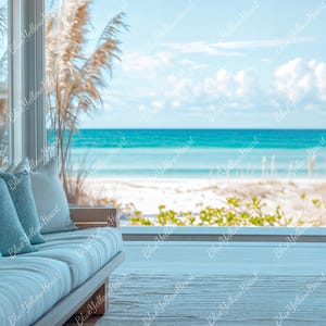 May include: A light-filled living room with a view of the ocean. A light blue sofa with several pillows sits in front of a large window. Decorative blue vases are on a shelf. The beach and ocean are visible through the window.