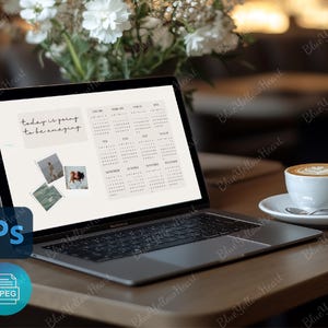 May include: A laptop computer with a white background and a calendar on the screen. The text "today is going to be amazing" is displayed on the screen. The laptop is on a wooden table with a cup of coffee and a plate.