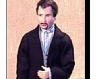 May include: A miniature doll figure of a man in a black suit with a long coat, black pants, and black shoes. The doll has a white shirt, a light blue vest, and a small mustache. The doll is standing upright.