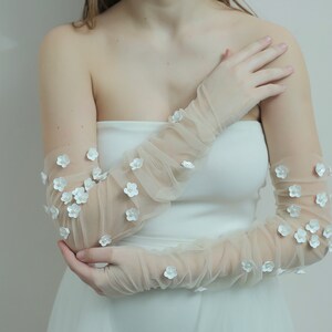 Kerry Parker fingerless gloves embellished with handmade flowers and pearls on them.