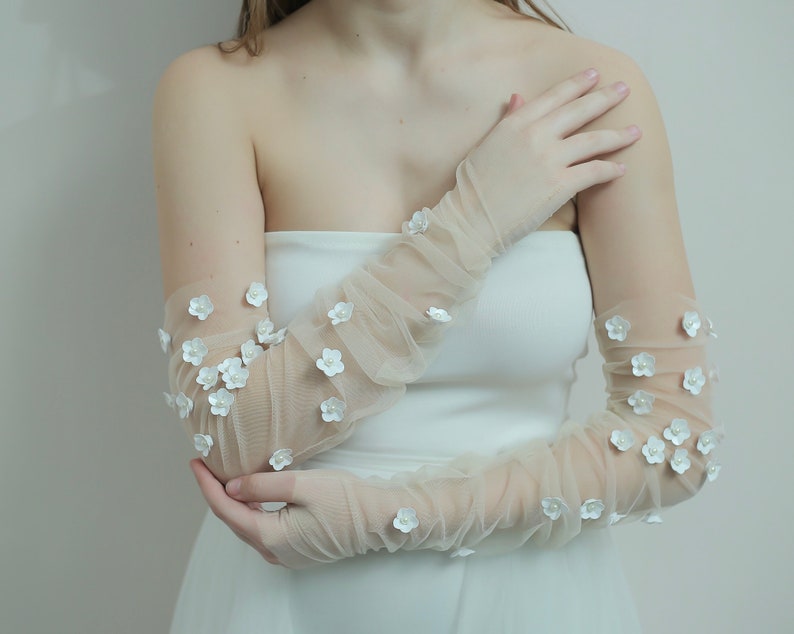 Kerry Parker fingerless gloves embellished with handmade flowers and pearls on them.