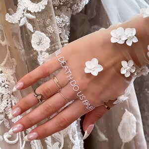Kerry Parker Gloves with hand embroidered vows. Embellished with handmade flowers and pearls on them.