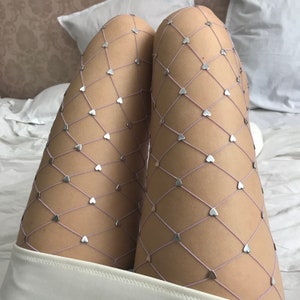 May include: Purple fishnet tights with silver heart-shaped embellishments.