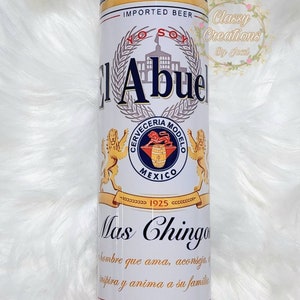 May include: A white and blue can with the text "El Abuel" and "Cerveceria Modelo" in a blue circle with a lion and the text "Mexico 1925". The can also has the text "Mas Chingon" and "IMPORTED BEER" on it.