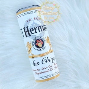 May include: White and gold can with the text "IMPORTED BEER" and "Mas Ching" with a crest featuring a lion and the text "Cerveceria Modelo" and "Mexico".
