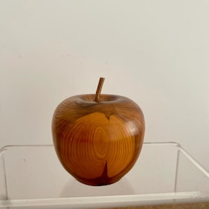 A mid century carved wooden apple ornament.