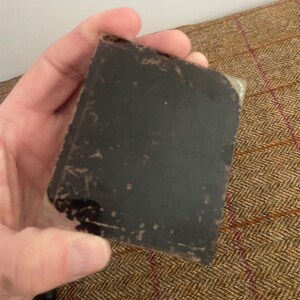 May include: A black and white photograph in a plastic sleeve. The photo is faded and has some scratches.