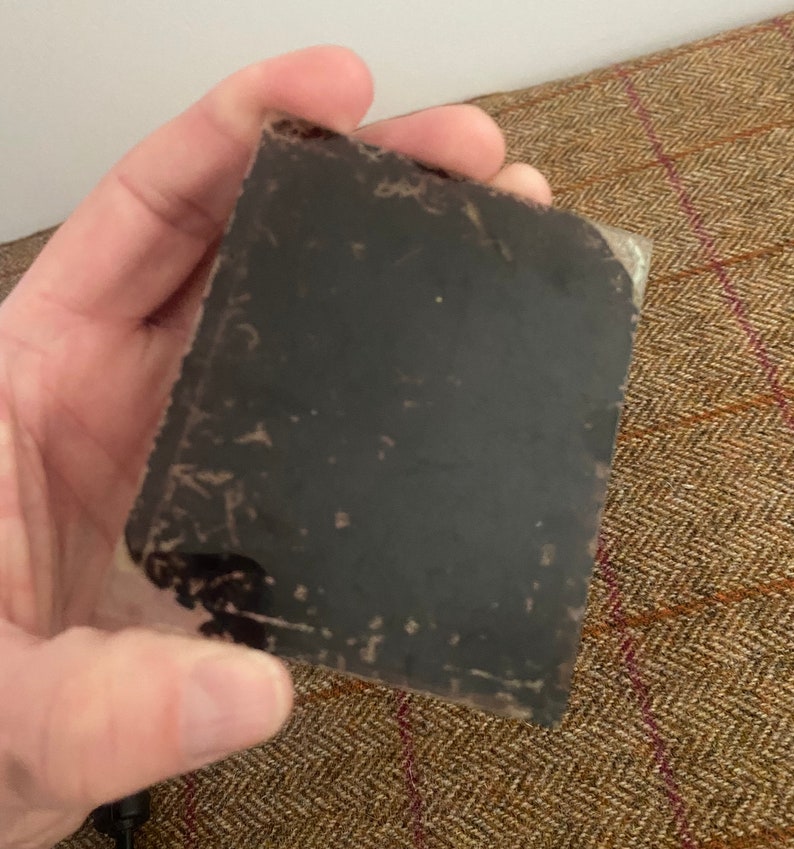 May include: A black and white photograph in a plastic sleeve. The photo is faded and has some scratches.