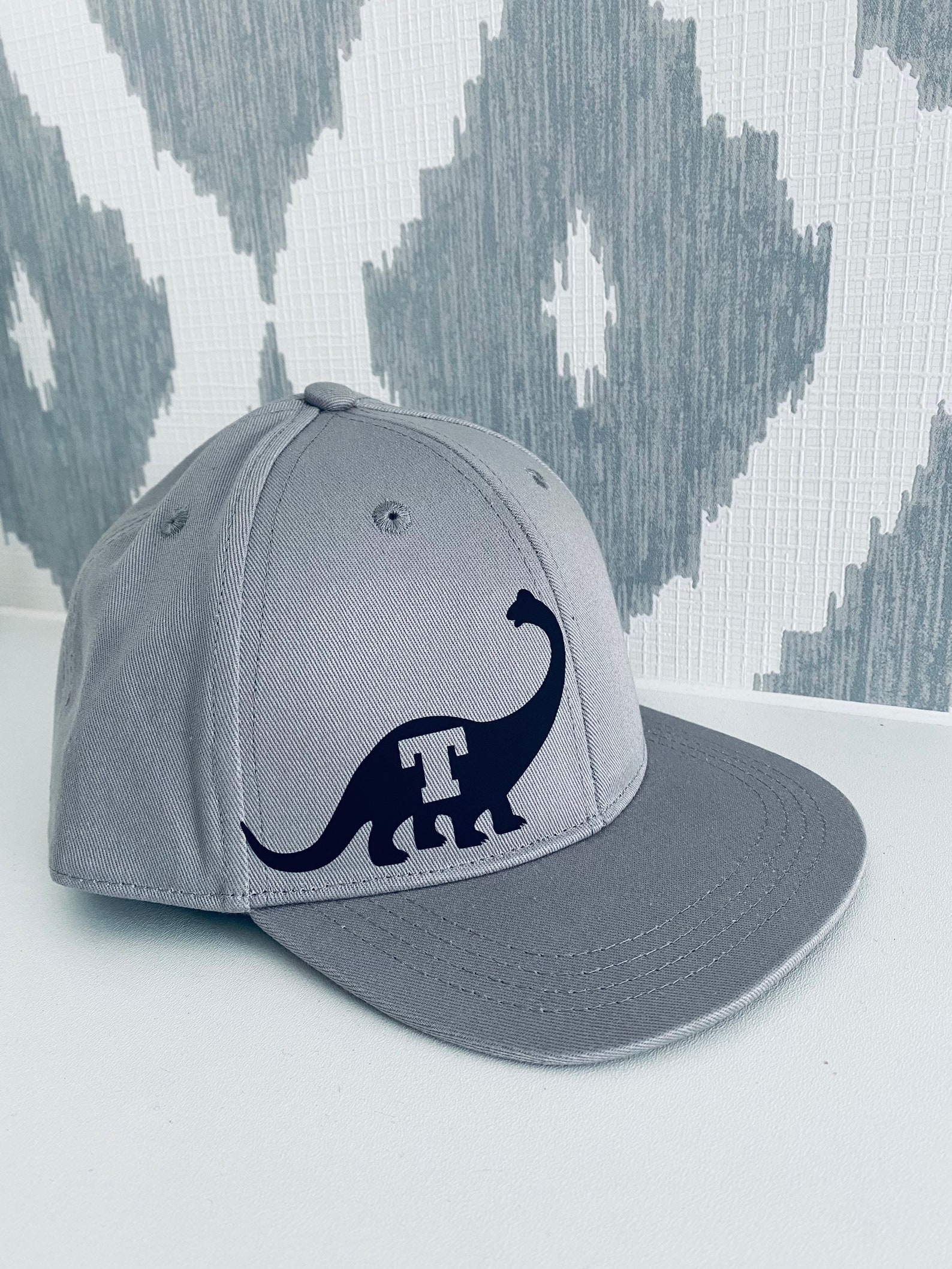 dinosaur with cap on head