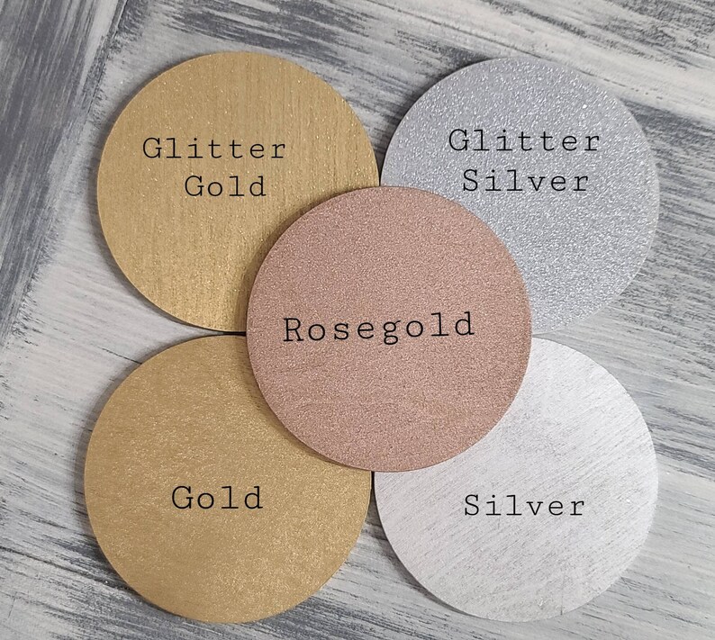 May include: Four round discs with different finishes: glitter gold, gold, rose gold, and glitter silver. Each disc has the finish name printed in black text.