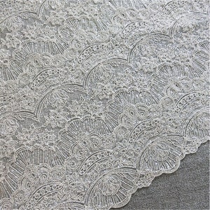 May include: White beaded lace fabric with a delicate floral pattern. The fabric features a repeating design of small, white beads arranged in a fan shape.