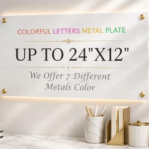 May include: A rectangular metal plate with a brushed silver finish, mounted with four gold-toned standoffs. The text reads: COLORFUL LETTERS METAL PLATE, UP TO 24"X12", and We Offer 7 Different Metals Color, featuring a decorative gold line element.