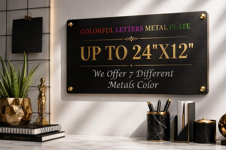 May include: A rectangular black metal plate with gold-colored text reading COLORFUL LETTERS METAL PLATE, UP TO 24"X12", and We Offer 7 Different Metals Color. The sign is mounted with four gold-colored circular fasteners at each corner.