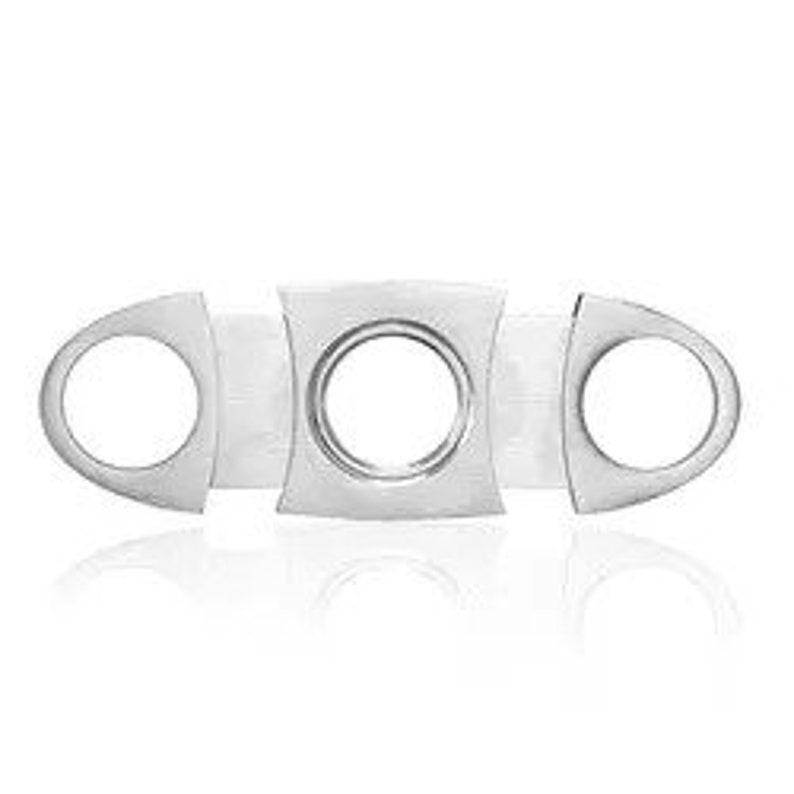 May include: Silver cigar cutter with three blades. The cutter has a rounded shape and a smooth, polished finish.