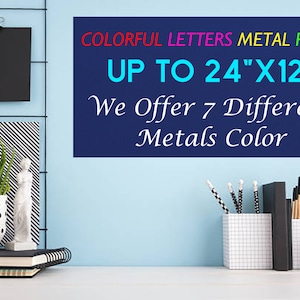 May include: A rectangular metal plate with the text COLORFUL LETTERS METAL PLATE UP TO 24"X12" We Offer 7 Different Metals Color. The sign features red, pink, yellow, and green text on a dark blue background, displayed on a light blue wall.