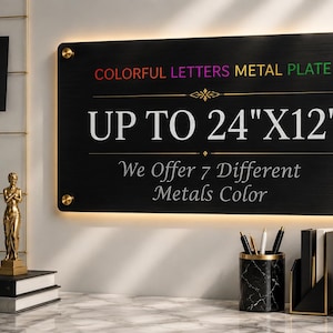 May include: A rectangular black metal plate with gold-toned mounting hardware, featuring the text COLORFUL LETTERS METAL PLATE, UP TO 24"X12", and We Offer 7 Different Metals Color, illuminated by a warm light source from behind the sign.