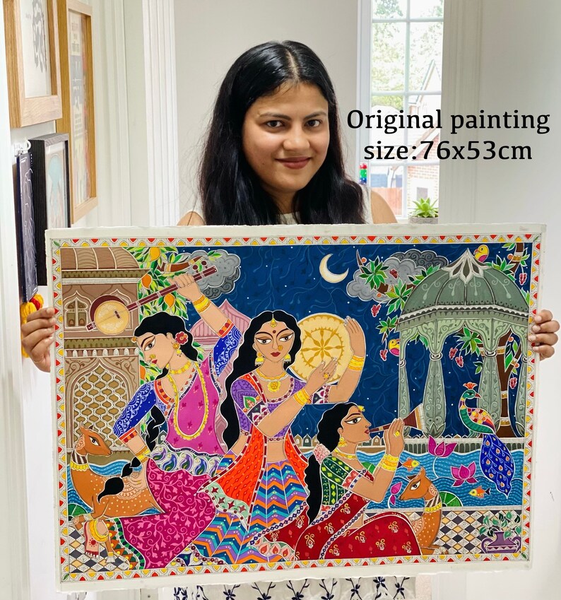 May include: A colourful painting depicting three women playing musical instruments in a night scene. The painting is framed and measures 76x53cm. The painting features a blue sky with a crescent moon, a green gazebo, and a peacock.