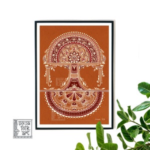 May include: A framed print of a traditional Indian folk art design. The artwork features a stylized tree with intricate details in white and red on a burnt orange background. The artist's signature and the year '23' are visible in the bottom right corner.
