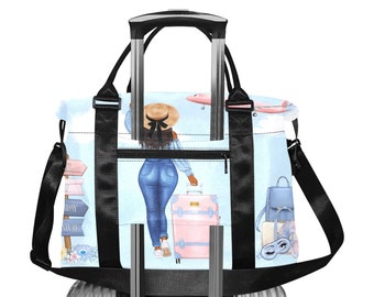 May include: A travel tote bag featuring a woman with a suitcase, airplane, and travel-themed imagery. The bag has black straps and a zipper closure. The design includes a light blue background with pink and blue accents, perfect for travel.