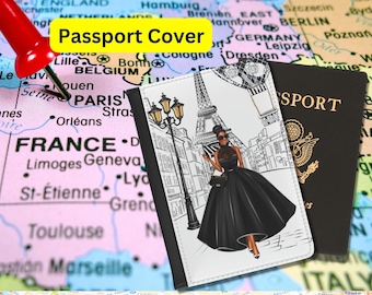 May include: Passport cover with a white background and a black and white illustration of a woman in a black dress standing in front of the Eiffel Tower. The text "Passport Cover" is printed in yellow on the cover.