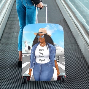 May include: A luggage cover with a blue sky background and a woman wearing a denim jacket, sunglasses, and a hat. The woman is standing in front of a white airplane. The text on the cover reads "Work Slay Travel Repeat."