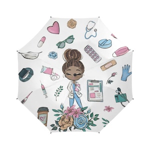 May include: White umbrella with a cartoon illustration of a Black female doctor with a stethoscope, medical supplies, and flowers. The doctor is wearing a white coat and blue scrubs.