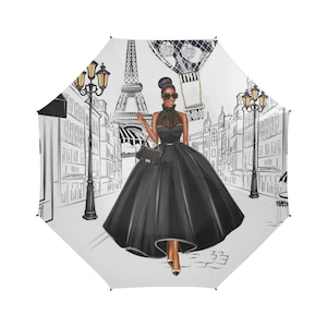May include: A black and white illustration of a woman in a black dress walking in Paris. The Eiffel Tower is in the background and a hot air balloon is in the sky.