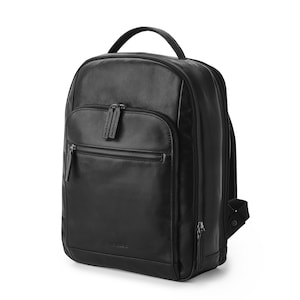 May include: A black leather backpack with a zippered front pocket and adjustable straps.