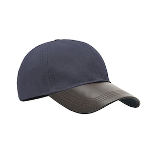May include: A navy blue baseball cap with a brown leather peak. The cap features a curved peak and a structured crown. The hat is a solid colour and appears to be made of a durable fabric.