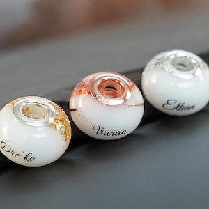 Breastmilk jewelry bead with silver, yellow or rose gold flakes, 925 sterling silver cores, gold plated options. Breastmilk bead keepsake.
