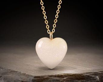 Breastmilk jewelry 18mm heart necklace with golden shimmer throughout. Keepsake from KeepsakeMom breast milk jewelry.