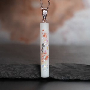 Breastmilk jewelry vertical long bar stick with silver and rose gold flakes with babys name and rose gold plated sterling silver chain. Keepsakemom