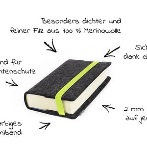 May include: A gray book cover made of 100% merino wool felt with a bright green elastic band. The felt is 2 mm thick on each side and has a 2 mm edge for protection. The elastic band helps to keep the book secure.