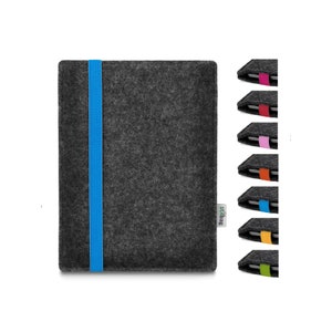 May include: A dark gray felt sleeve for a tablet or e-reader featuring a vertical bright blue elastic closure band. A small white fabric tag with the text stilbag is attached to the side. A column of seven additional color variations is shown.