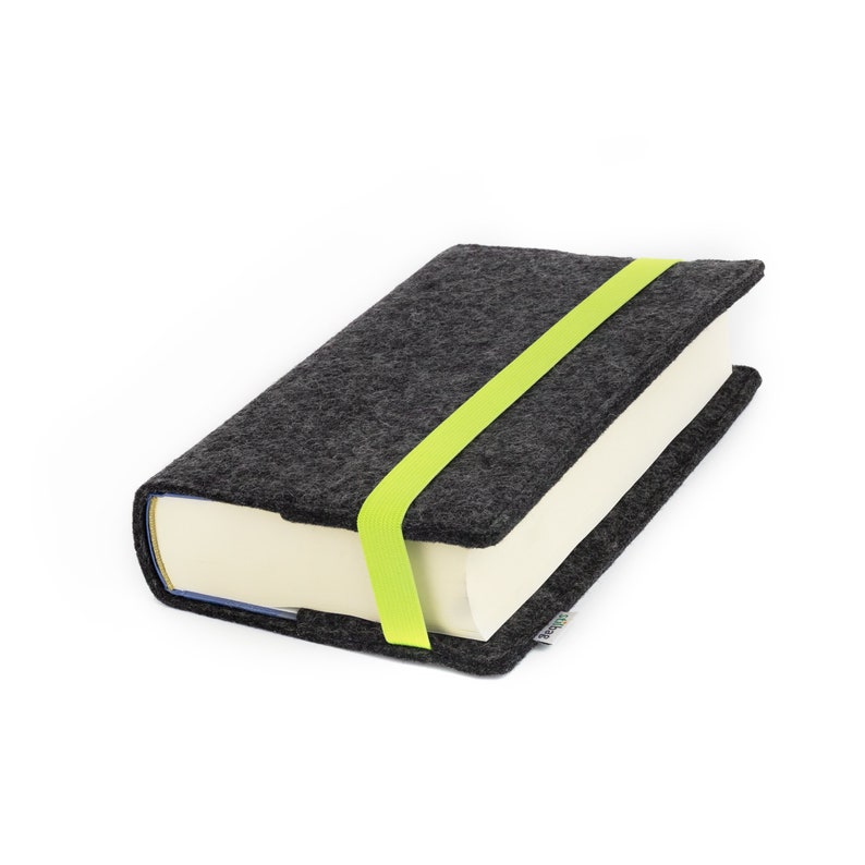 May include: A gray felt book cover with a bright green elastic closure. The cover is designed to protect a book.