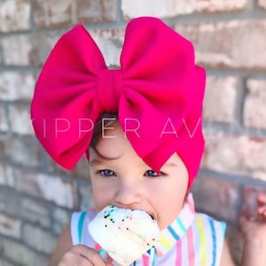 May include: A white ceramic mug with a black handle and the text "But First, Coffee" in a black, handwritten-style font. The mug is on a white surface.