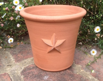 Handmade small terracotta pot with raised decoration. Hand made terracotta flower pot.